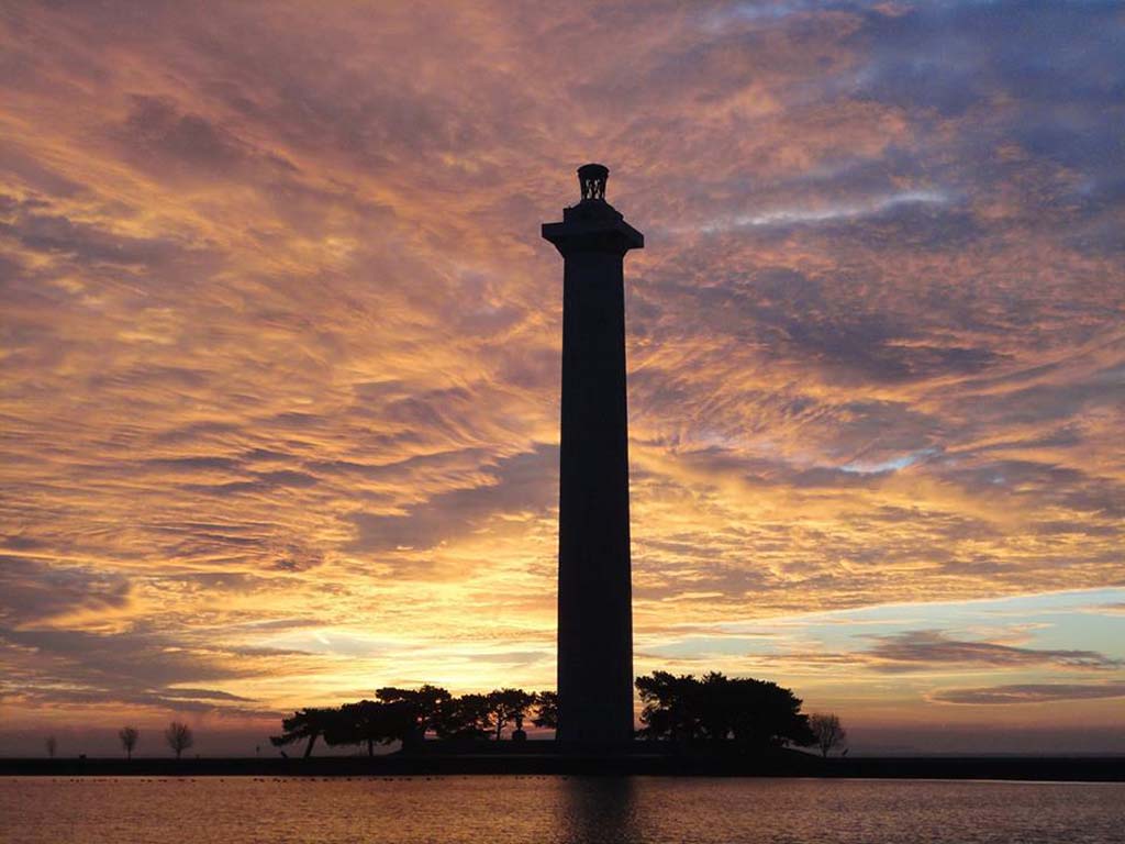 8 Outstanding National Parks in Ohio 11 The sunset casts orange and purple hues on the clouds behind Perry's Victory and International Peace Memorial, one of the national parks in Ohio