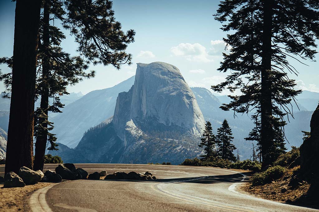Yosemite Itinerary: 5 Ideas for Day-to-Day Experiences in an Iconic National Park 48 A paved road curves with a view of Yosemite National Park's Half Dome