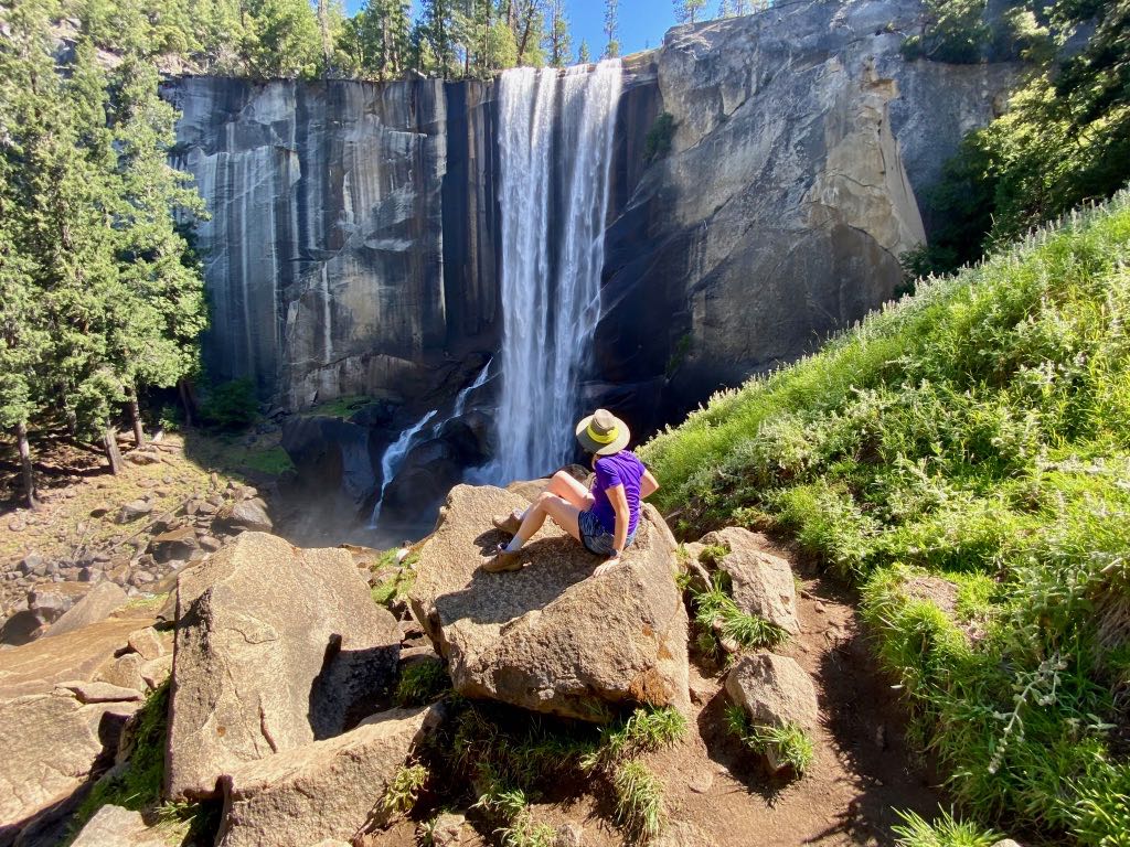 Hiking the Yosemite Mist Trail: Is It Worth the Climb? 34 A hiker sits on a rock while staring at Vernal Falls