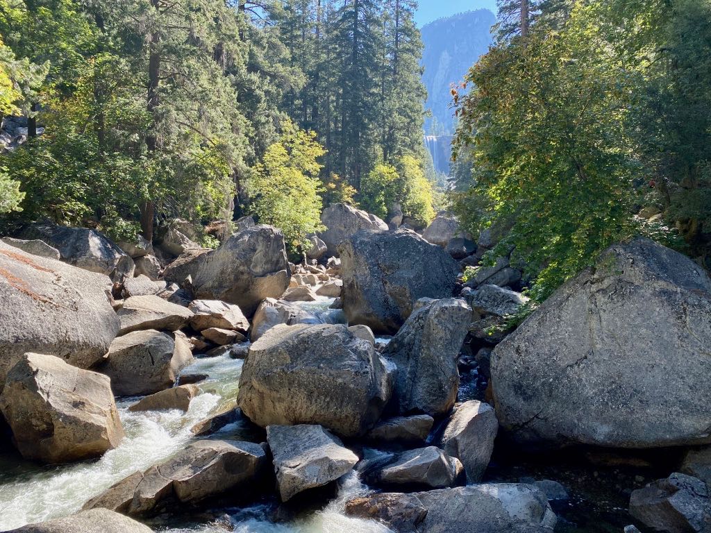 Hiking the Yosemite Mist Trail: Is It Worth the Climb? 31 The top of Vernal Falls is seen above the green trees and Merced River
