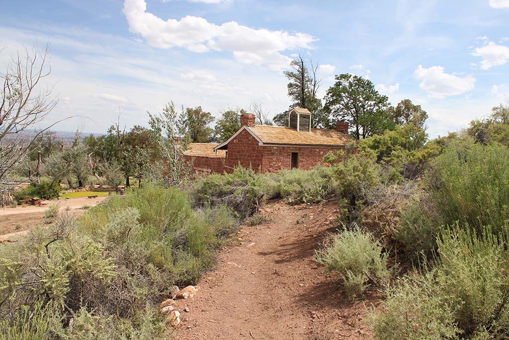 22 Amazing National Parks in Arizona 42 A red trail made of dirt leads to a small building