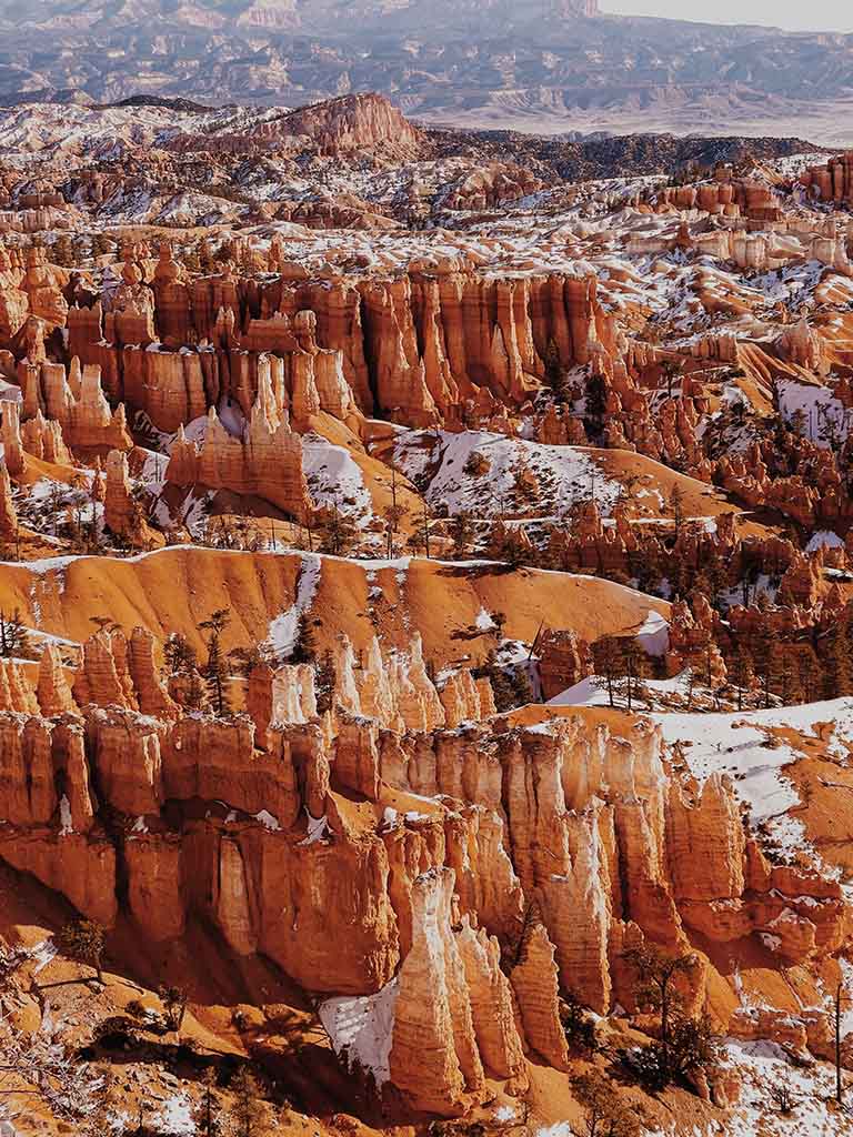 12 Beautiful Hikes in Bryce Canyon National Park 3 Snow-covered orange rocks filled in a canyon