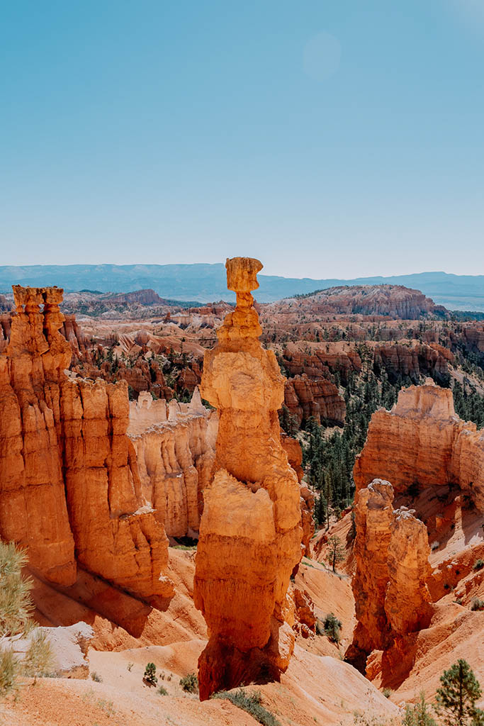 12 Beautiful Hikes in Bryce Canyon National Park 8 A tall orange hoodoo surrounded by red and orange canyon walls