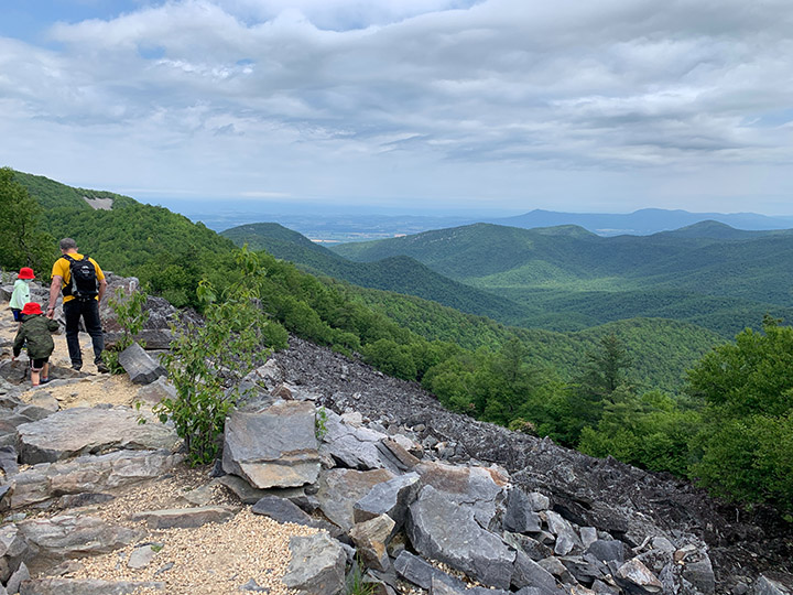 Shenandoah Camping: A Comprehensive Guide to All 5 Shenandoah Campgrounds 10 A family group of hikers on a stone trail in Shenandoah