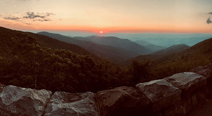 Shenandoah Camping: A Comprehensive Guide to All 5 Shenandoah Campgrounds 30 An orange sunrise over blue hazing mountains while camping in Shenandoah