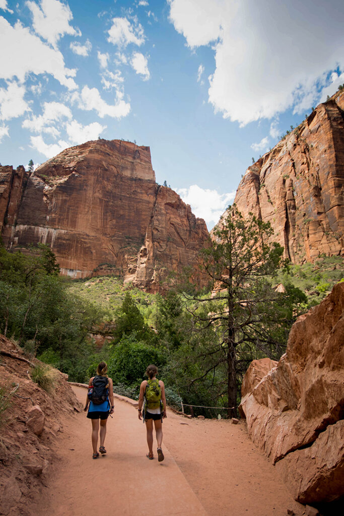One Day in Zion: 4 Ways to Spend an Epic 24 Hours in Zion National Park 31 Two female hikers on a paved trail during a day trip to zion