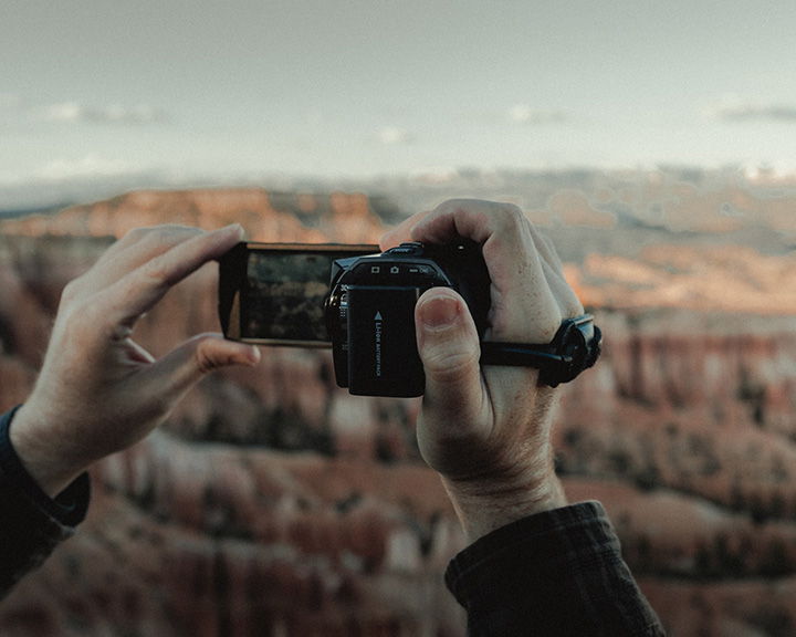 20 Fun Things to Do in Bryce Canyon National Park 44 A person holds a camera up to take a picture of Bryce Amphitheater