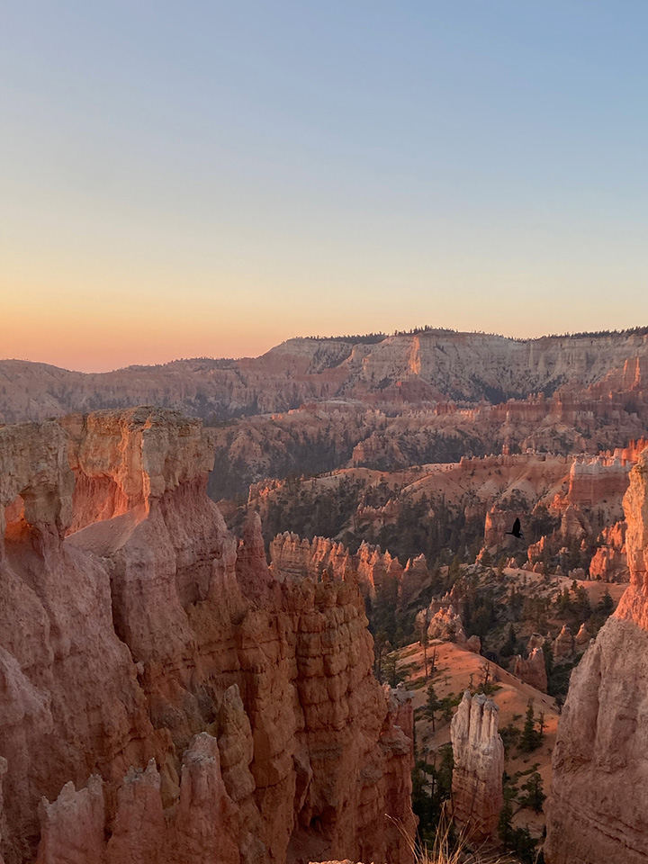 20 Fun Things to Do in Bryce Canyon National Park 2 A hazy sunset over an amphitheater filled with orange hoodoos