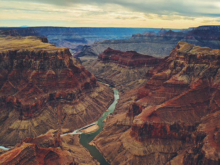 13 Inspiring Things to Do in Grand Canyon National Park 3 The Colorado River runs through a deep red, orange, and brown canyon