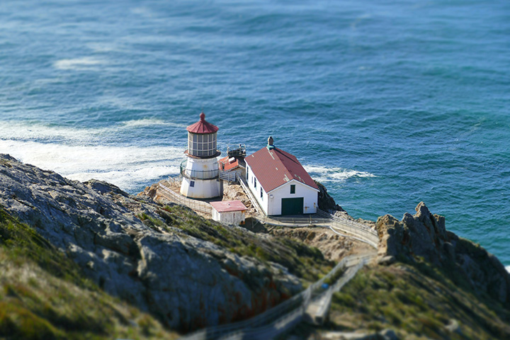 20 Incredible Things to Do in Point Reyes National Seashore 10 A lighthouse with a red roof sits precariously on a rocky cliff