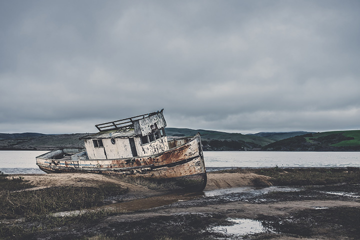 20 Incredible Things to Do in Point Reyes National Seashore 29 An old boat laying on sandy shores is one of the best things to see in Point Reyes.