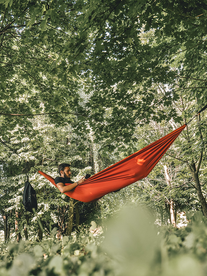 The 31 Best National Park Books for Every Reader 40 A man in an orange hammock reading national park books