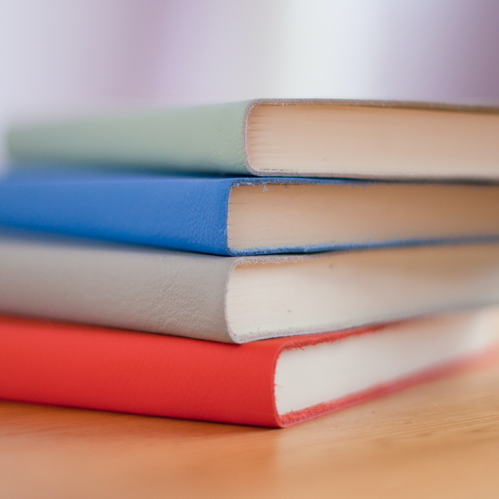 The 31 Best National Park Books for Every Reader 34 A stack of gray, blue, and red books on a table