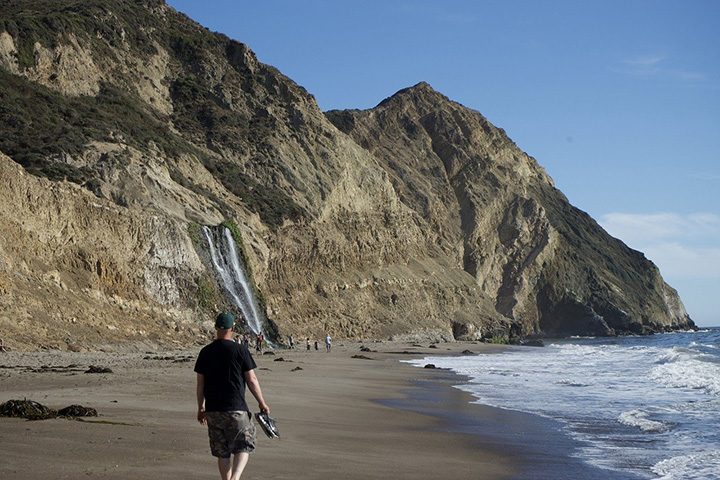 Alamere Falls Hike: The Ultimate Guide for Hiking to One of California’s Bucket-List Waterfalls 7 Hikers walk on a sandy beach toward Alamere Falls