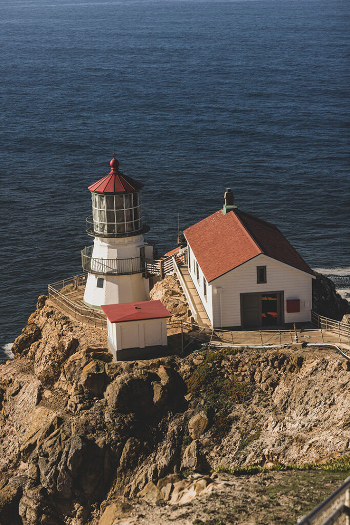 Alamere Falls Hike: The Ultimate Guide for Hiking to One of California’s Bucket-List Waterfalls 3 A lighthouse with a red roof is precariously perched on a rock outcropping on the coast