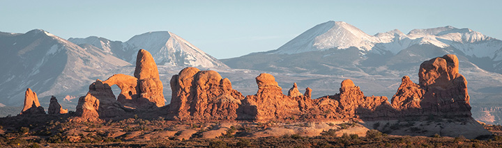 Ultimate Guide to an Epic One Day in Arches National Park Itinerary 33 A series of arches and red rocks below snow-capped peaks