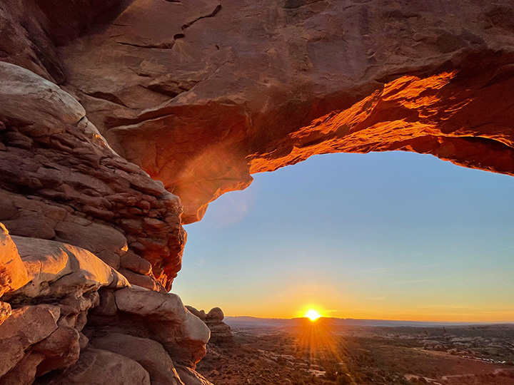 Ultimate Guide to an Epic One Day in Arches National Park Itinerary 64 The setting sun viewed through a rock arch