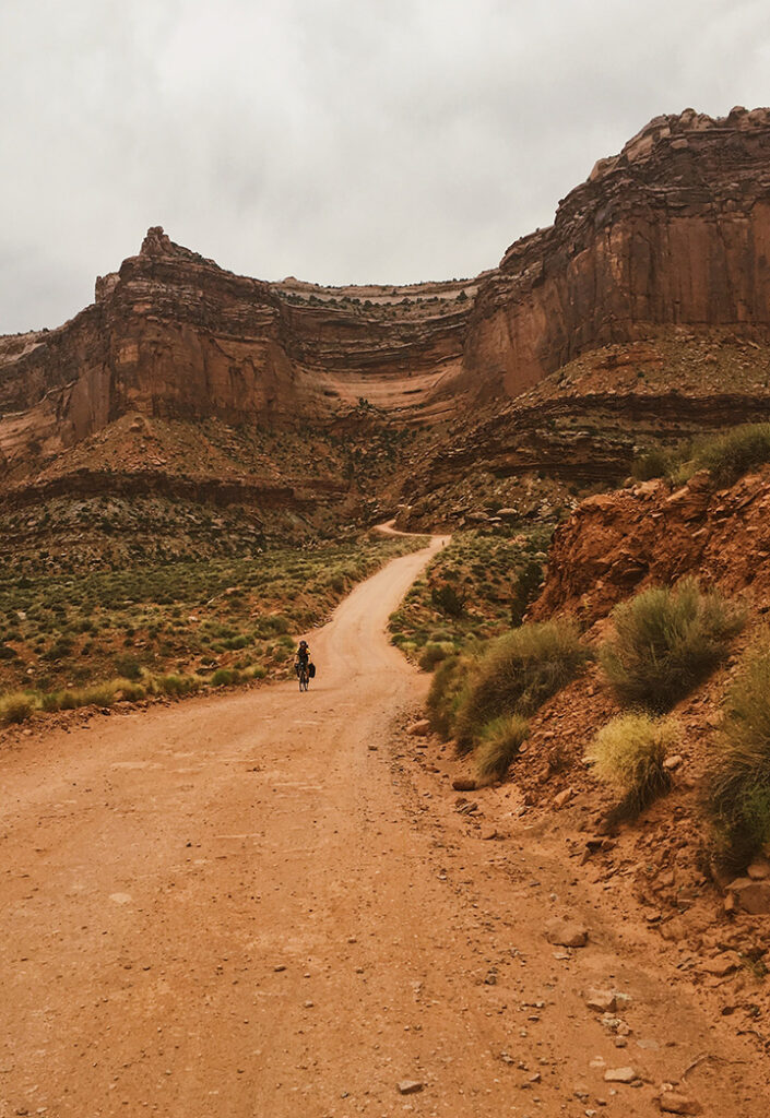 The 15 Best Hikes in Canyonlands National Park: A Comprehensive Guide 5 A bicyclist on a dirt road in a canyon