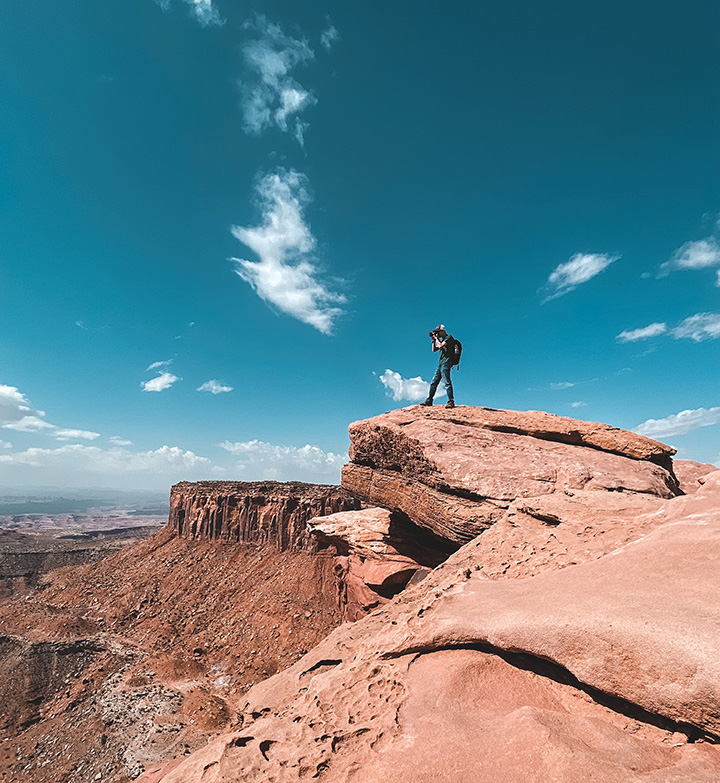 The 15 Best Hikes in Canyonlands National Park: A Comprehensive Guide 9 A hiker standing on orange slickrock