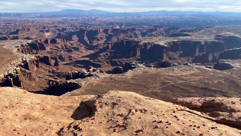 The 15 Best Hikes in Canyonlands National Park: A Comprehensive Guide 28 An overlook of a canyon with a river running through it