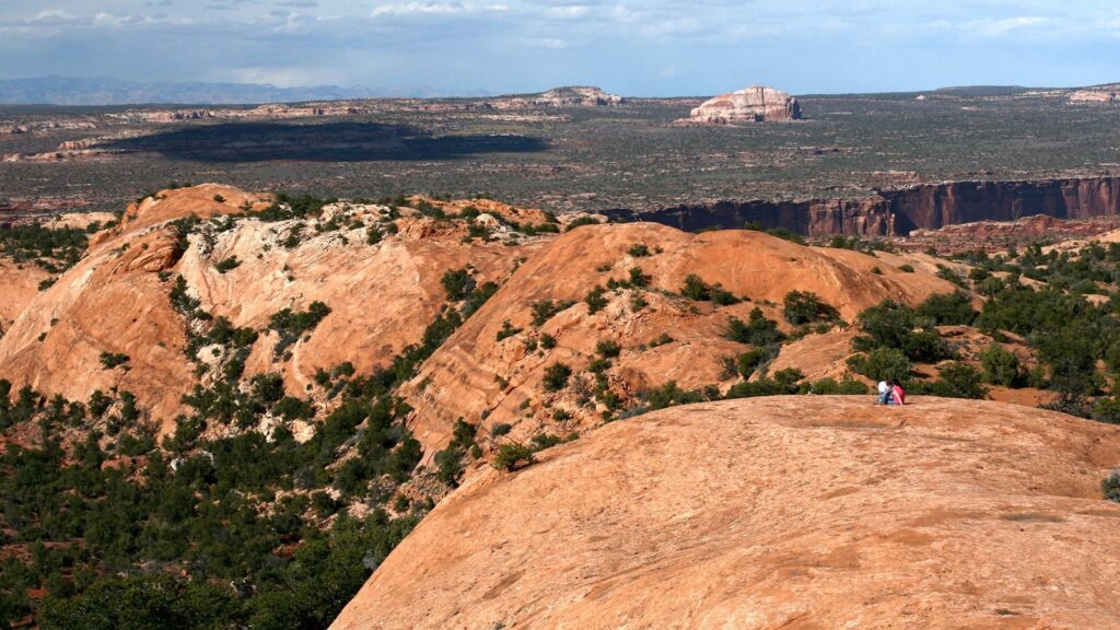 The 15 Best Hikes in Canyonlands National Park: A Comprehensive Guide 33 A large orange rock made of sandstone above a canyon
