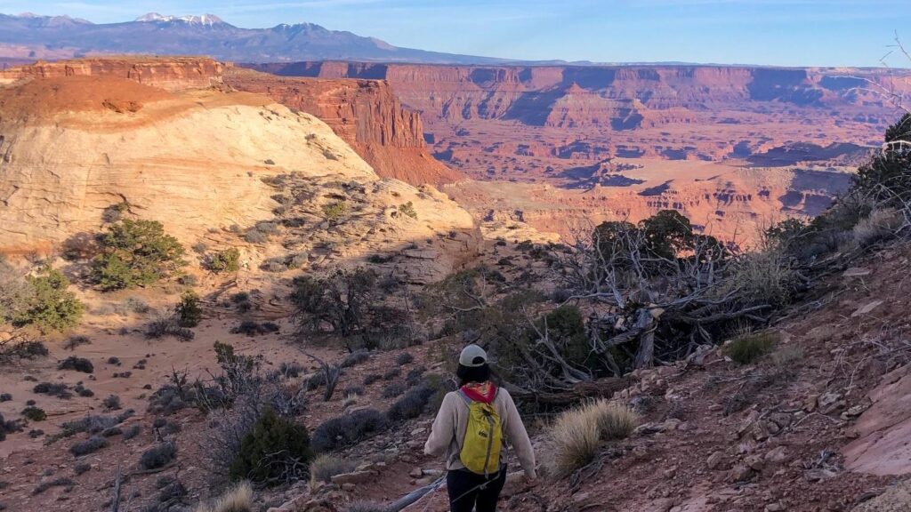 The 15 Best Hikes in Canyonlands National Park: A Comprehensive Guide 49 A woman hikes toward a canyon