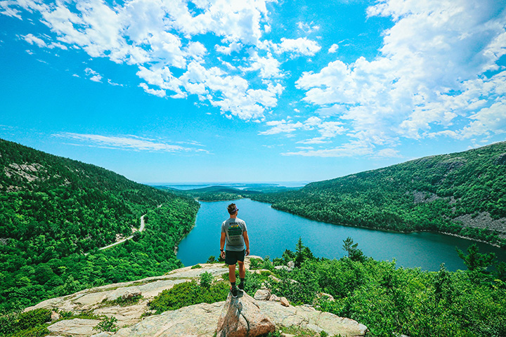 The 15 Best National Park Scratch Off Maps and Posters 2 A male hiker takes in the view from the top of a rock