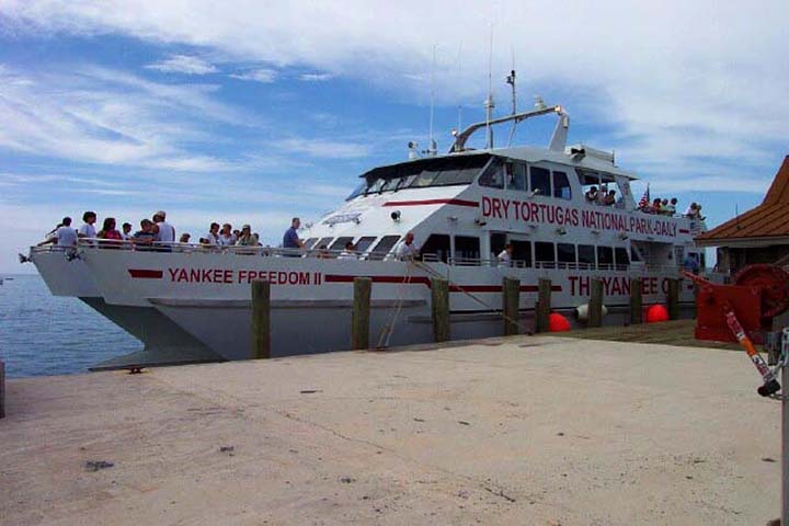 The Absolute Best Time to Visit Dry Tortugas National Park 16 A white ferry with red writing docked at a beach