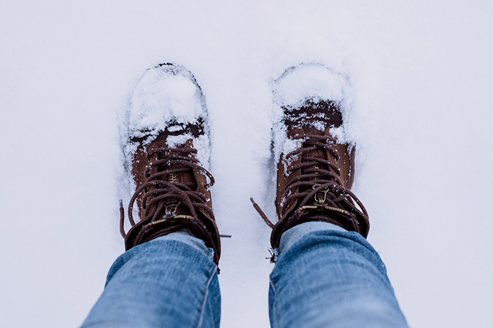 11 Hiking Safety Tips for Your Next Trail Adventure 8 A hiker photographs their snow-covered boots
