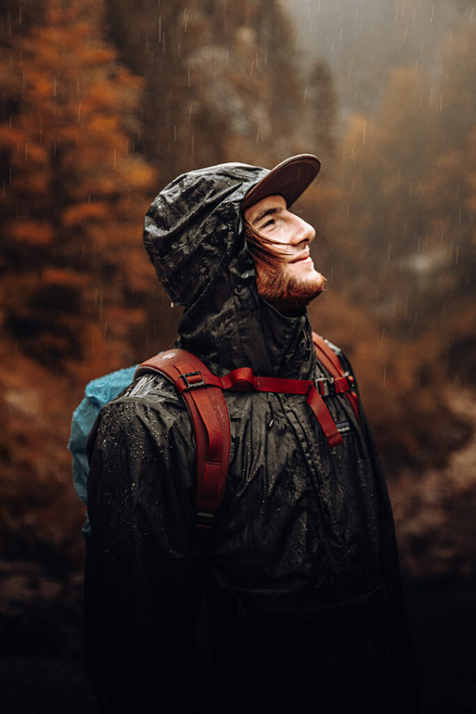 11 Hiking Safety Tips for Your Next Trail Adventure 7 A hiker walks on a trail through the rain