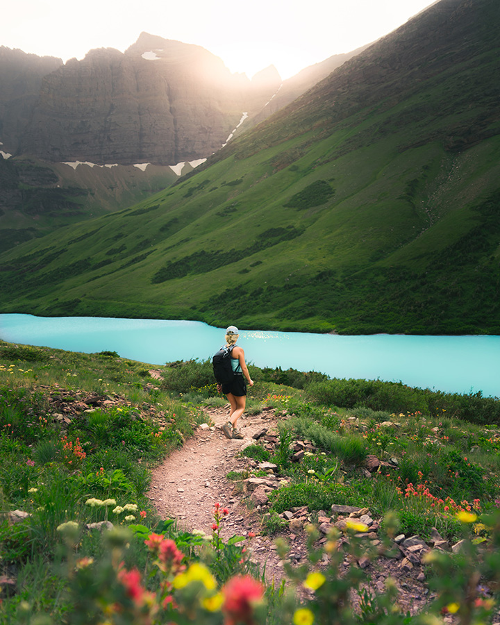 11 Hiking Safety Tips for Your Next Trail Adventure 5 A female hiker walks on a trail through the mountains