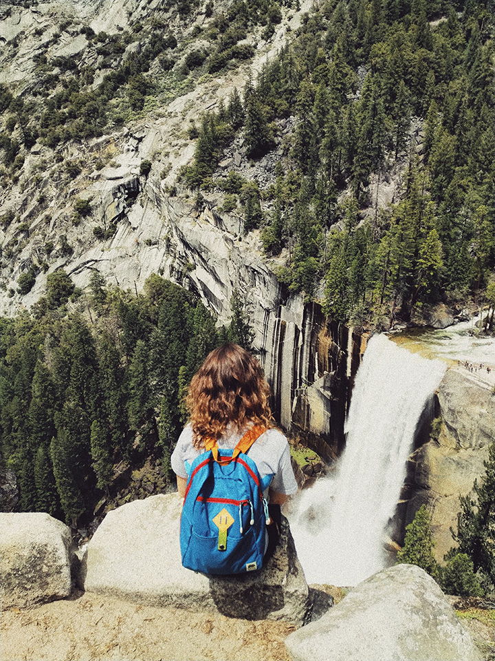 11 Hiking Safety Tips for Your Next Trail Adventure 14 A hiker takes a break to admire a waterfall