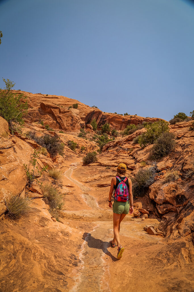 11 Hiking Safety Tips for Your Next Trail Adventure 24 A female hiker walks on a trail through the desert