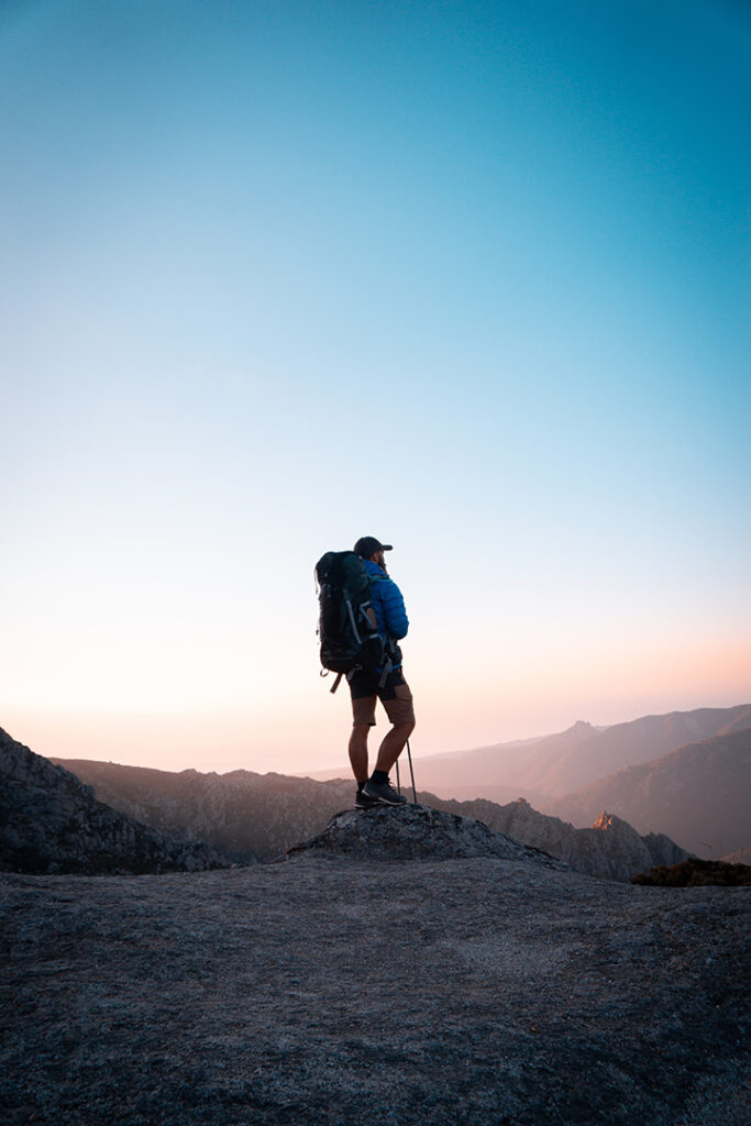 11 Hiking Safety Tips for Your Next Trail Adventure 25 A male hiker walks on a trail through the mountains