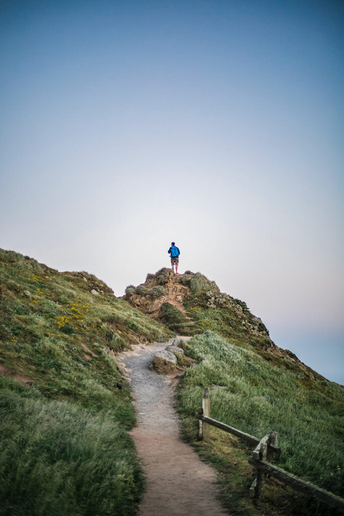 11 Hiking Safety Tips for Your Next Trail Adventure 2 A male hiker walks on a trail through the tundra