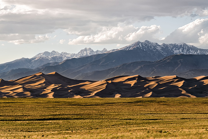 Great Sand Dunes Itinerary: One Day in Great Sand Dunes National Park 33 Large sand dunes in the foreground with a mountain range in the background