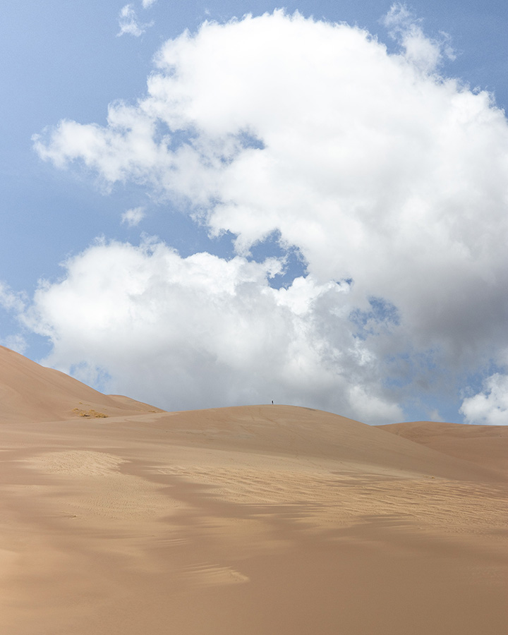 Great Sand Dunes Itinerary: One Day in Great Sand Dunes National Park 11 Sand dunes against a partly cloudy sky