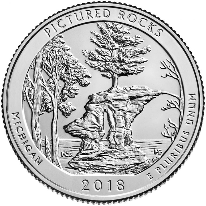 56 National Park Quarters List (With Pictures!) 28 A national park quarter for Pictured Rocks with trees and rocks in a lake