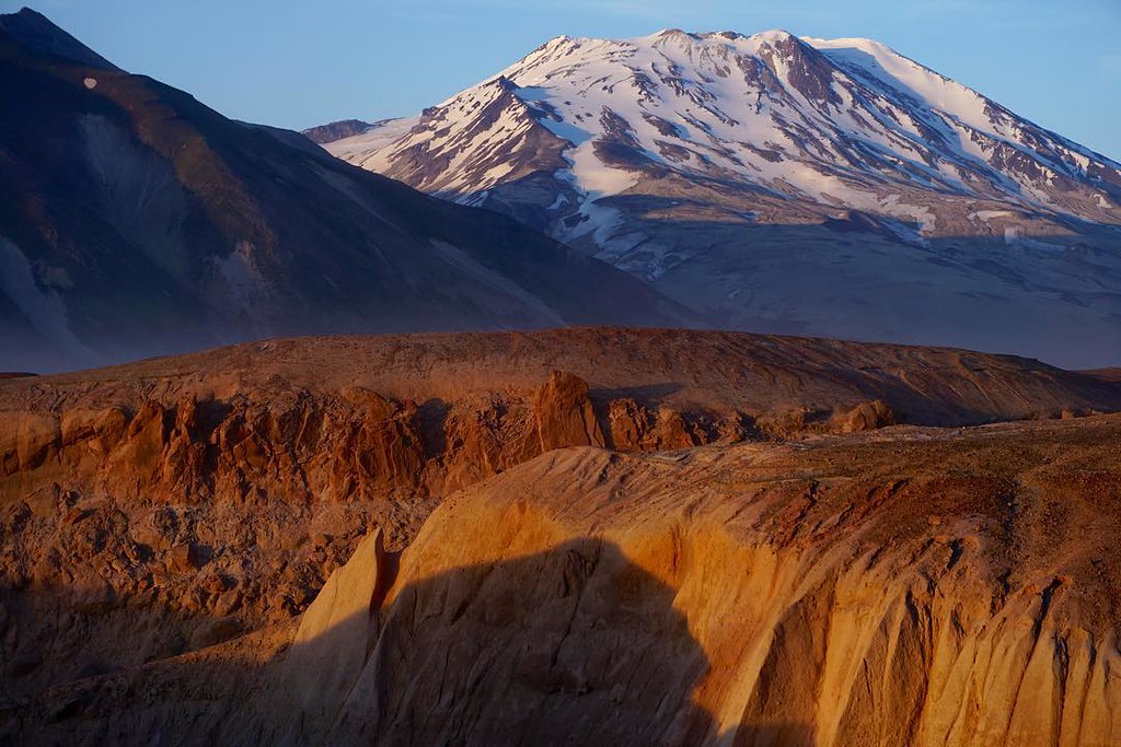 The 13 Best Things to Do in Katmai National Park: Bears and Volcanoes Galore 8 A snow-capped peak above a barren orange landscape