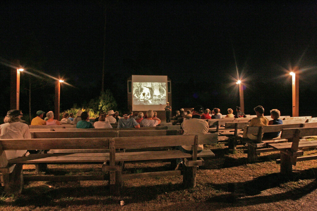 Everglades National Park Camping Guide: Everything You Need to Know 12 An audience sits on wooden benches while listening to a ranger program at one of the campgrounds in Everglades National Park.