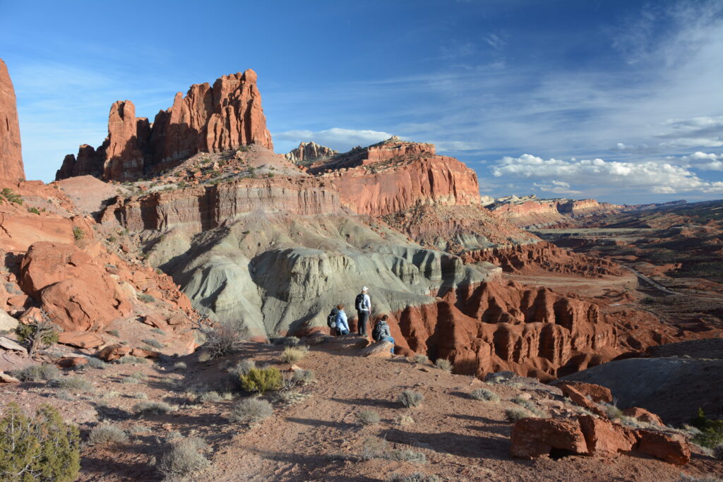 20 Best Hikes in Capitol Reef National Park 31 Orange and gray geologic remnants in a canyon below a trail