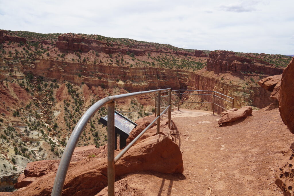20 Best Hikes in Capitol Reef National Park 14 Metal railings prevent falls from an overlook on orange rock