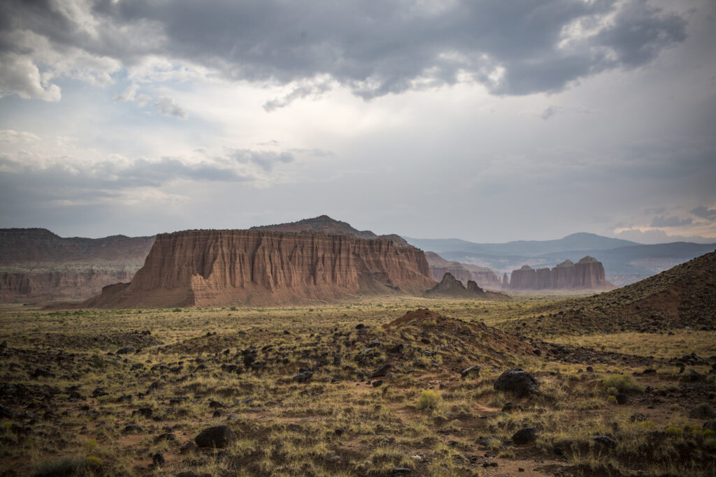 20 Best Hikes in Capitol Reef National Park 13 Large rock monoliths below gray skies