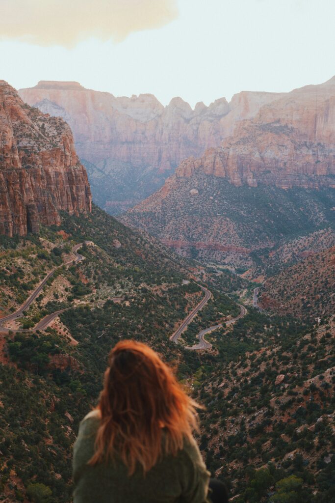 Closest Airports to Zion National Park: How to Get to Zion National Park, Utah 10 A hiker with red hair stands at a viewpoint in Zion National Park to take in the view