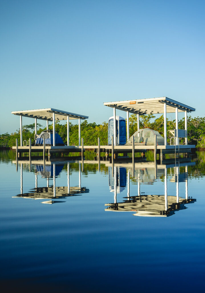 Everglades National Park Camping Guide: Everything You Need to Know 20 Two wooden platforms above a blue waterway. These are called chickees and are one of many options for camping in Everglades National Park wilderness.