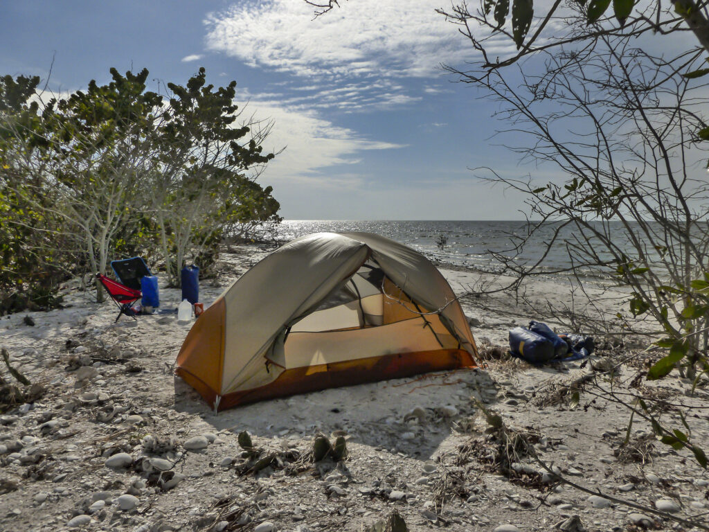 Everglades National Park Camping Guide: Everything You Need to Know 22 A red and yellow tent on a beach. Beach camping in the Everglades is possible!