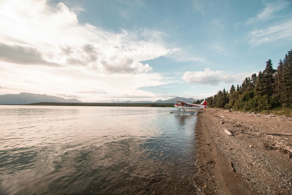 How to Get to Katmai National Park: Boats, Planes, and Bears, Oh My! 10 A float plane in the distance sitting on a beach (how to get to Katmai National Park - fly)