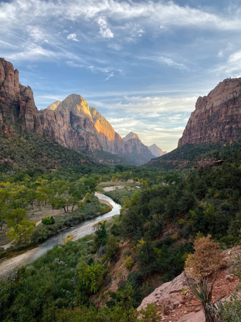 Closest Airports to Zion National Park: How to Get to Zion National Park, Utah 5 A river runs through a canyon of green trees below towering rock monoliths