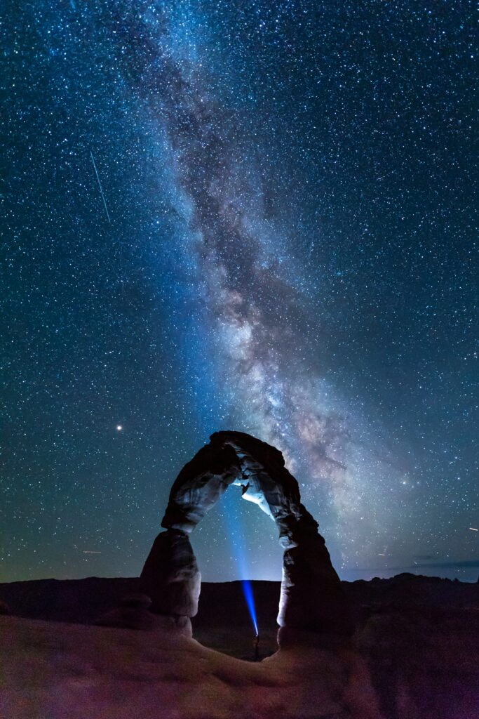 A List of All 63 National Parks in the U.S. Ranked by Their Popularity 3 The milk way shines brightly behind a tall rock arch