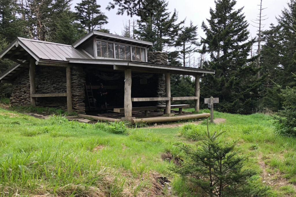 Hiking Alum Cave Trail in Great Smoky Mountains National Park 29 A wooden shelter along a trail in the grass
